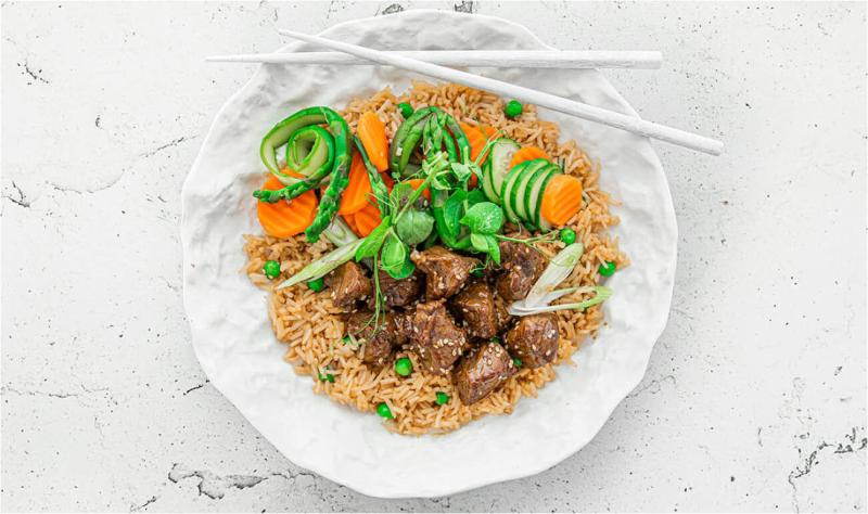 Stir-fried beef served with basmati rice, asparagus, carrots & cucumber
